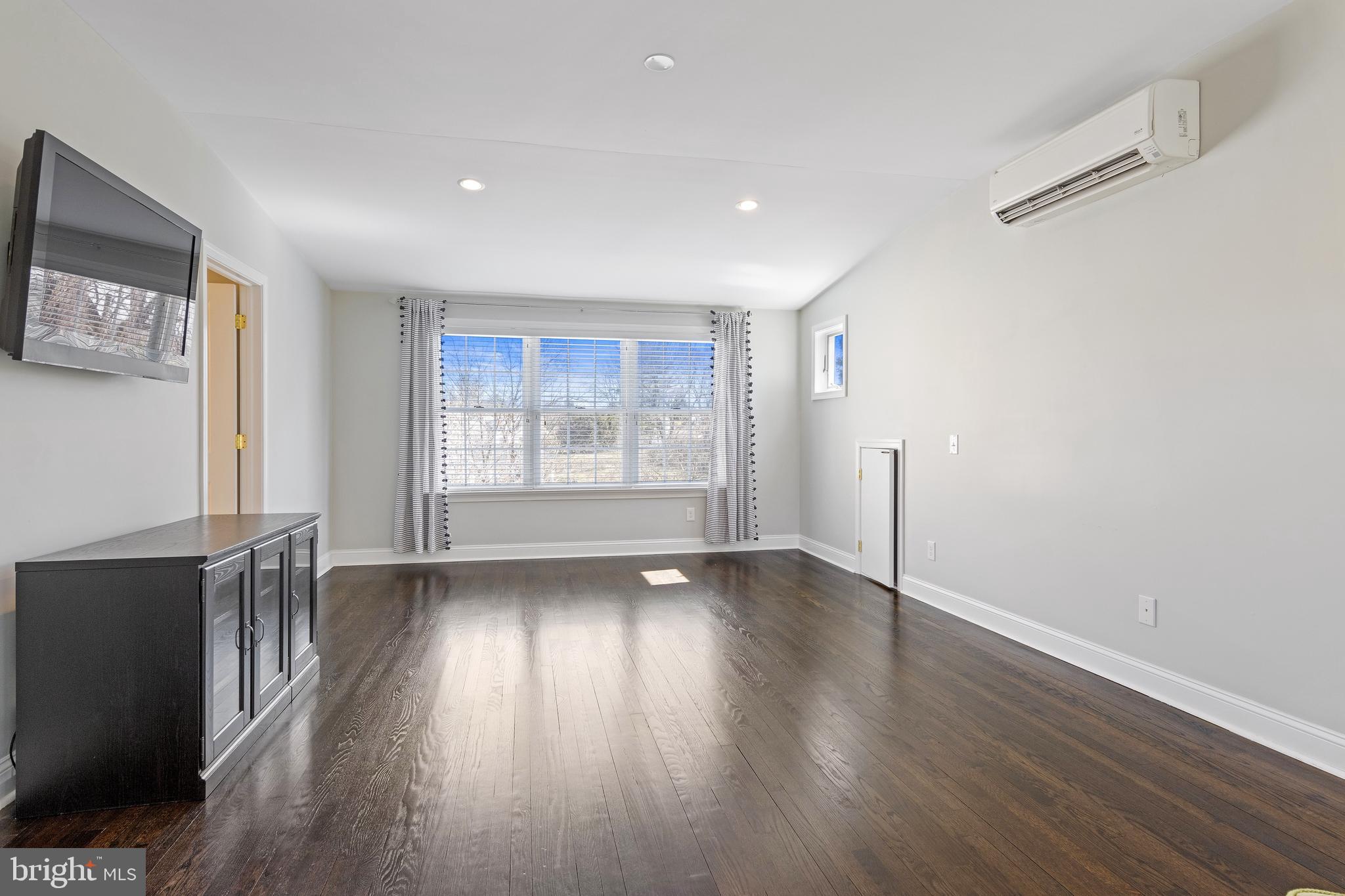129 Clover Hill Lane Wayne, PA 19087 - Photo 24 of 41 a view of an empty room with wooden floor and a window