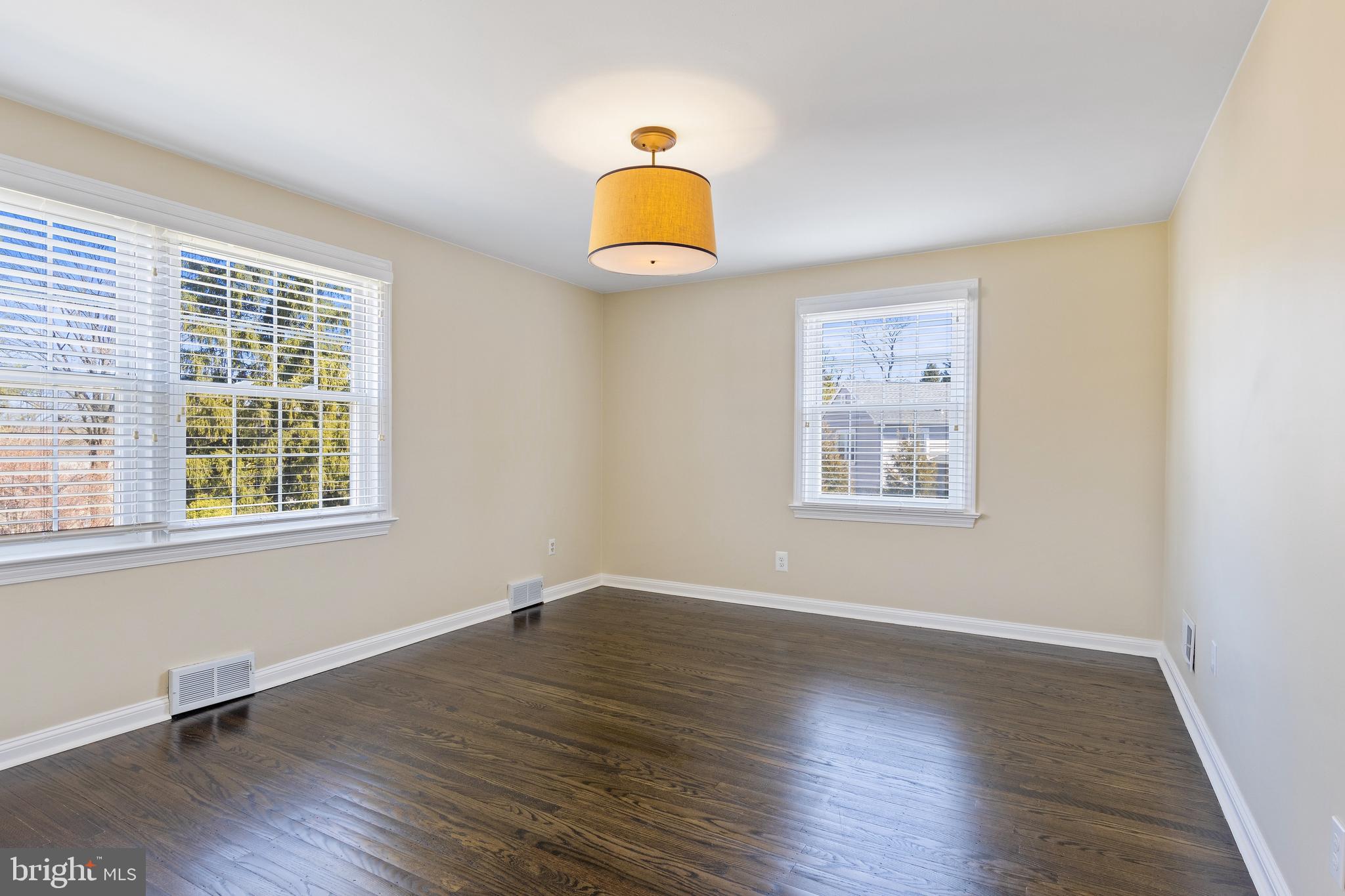 129 Clover Hill Lane Wayne, PA 19087 - Photo 29 of 41 a view of a bedroom with wooden floor and a window