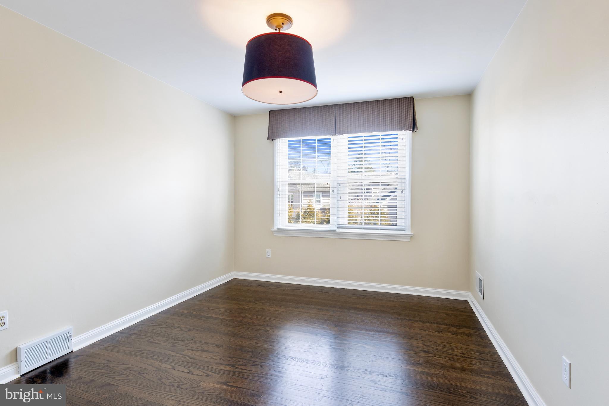 129 Clover Hill Lane Wayne, PA 19087 - Photo 30 of 41 an empty room with wooden floor and windows