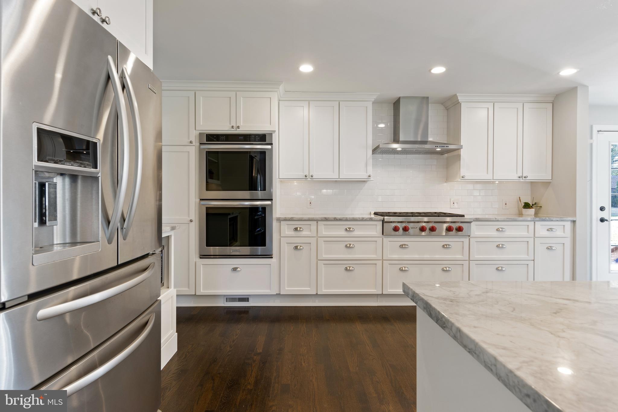 129 Clover Hill Lane Wayne, PA 19087 - Photo 5 of 41 a kitchen with granite countertop white cabinets and stainless steel appliances
