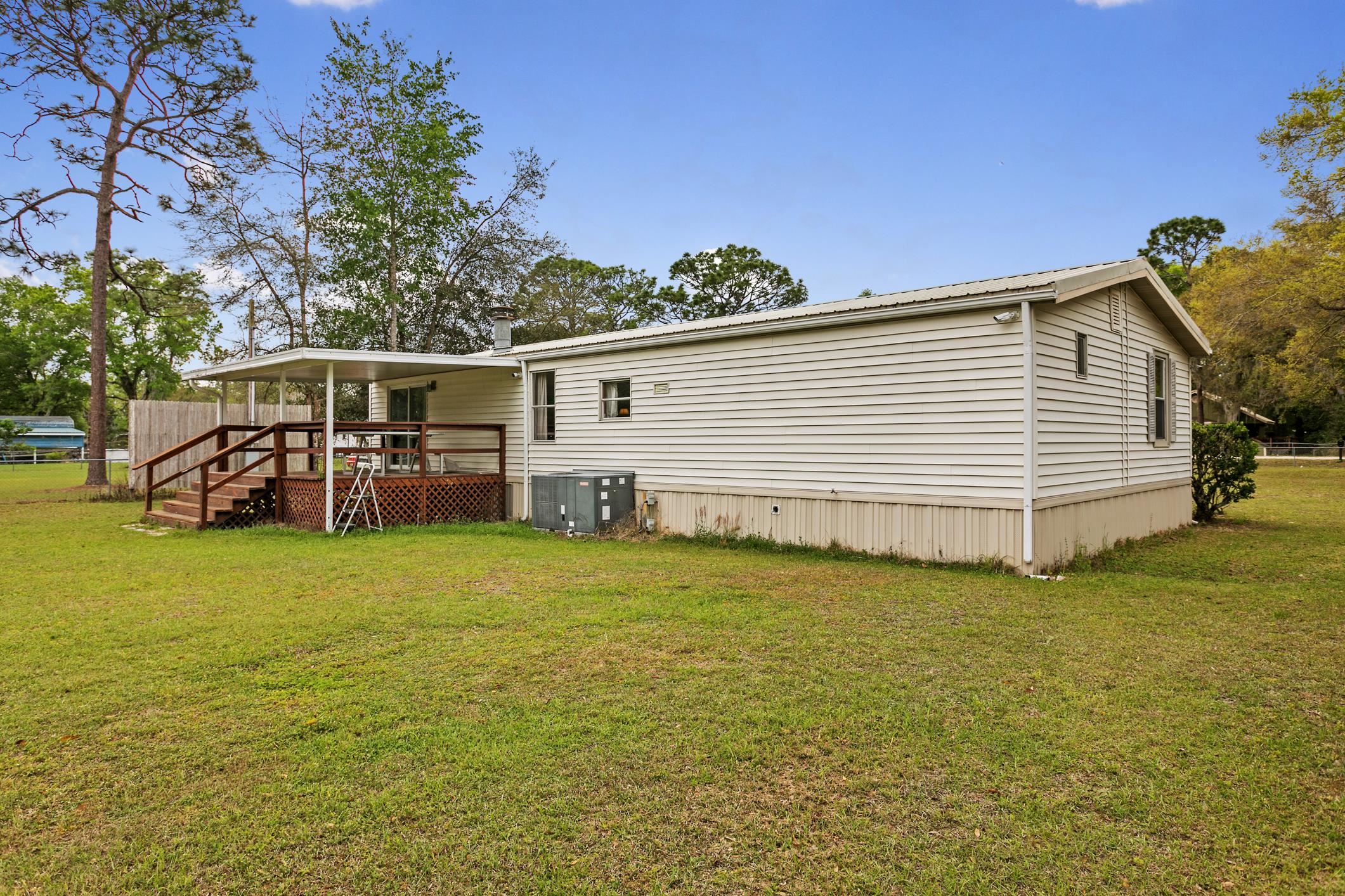 3913 Randall Road Green Cove Springs, FL 32043 - Photo 32 of 43 a view of a house with a yard