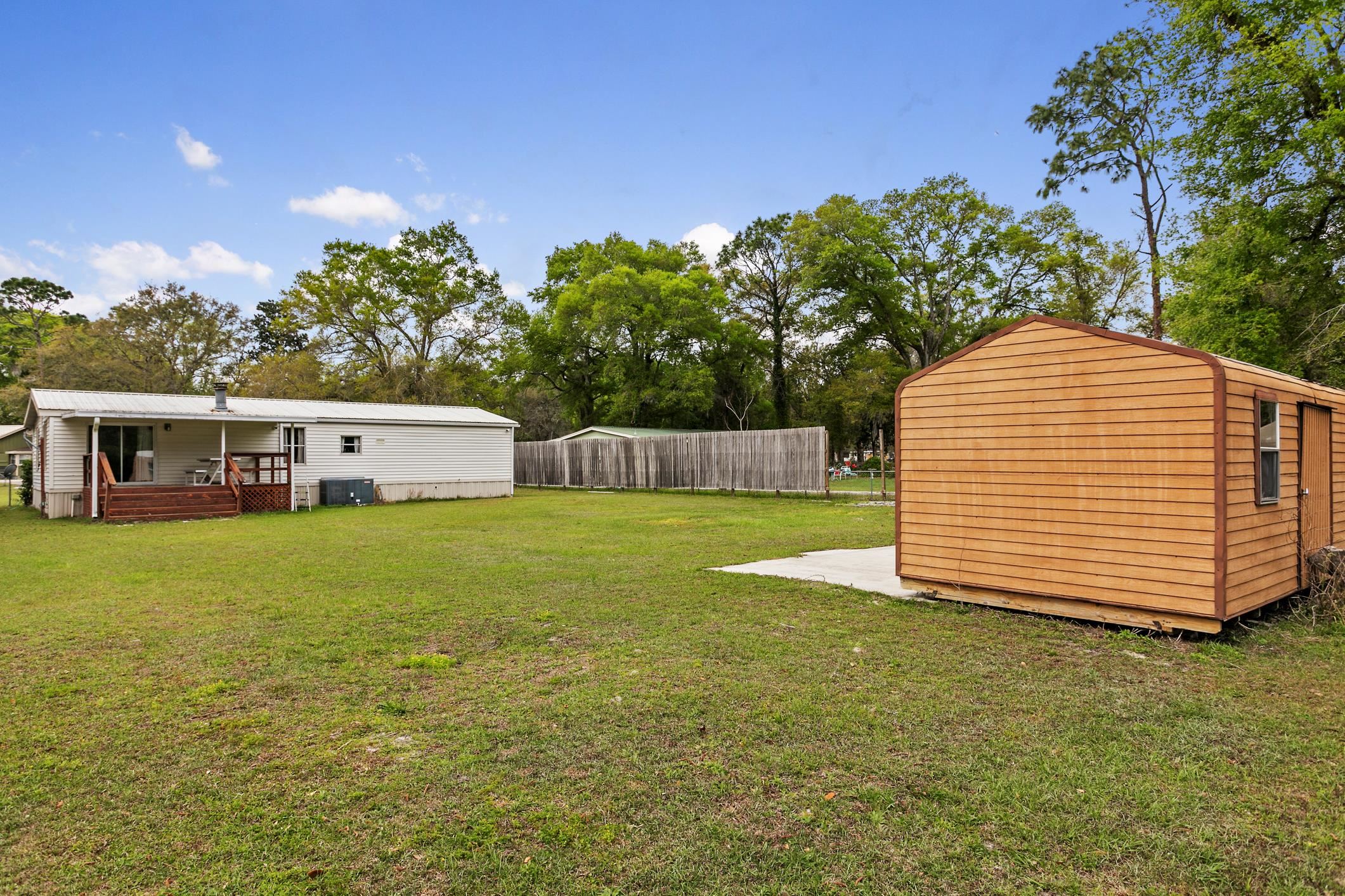 3913 Randall Road Green Cove Springs, FL 32043 - Photo 34 of 43 a view of a house with a backyard