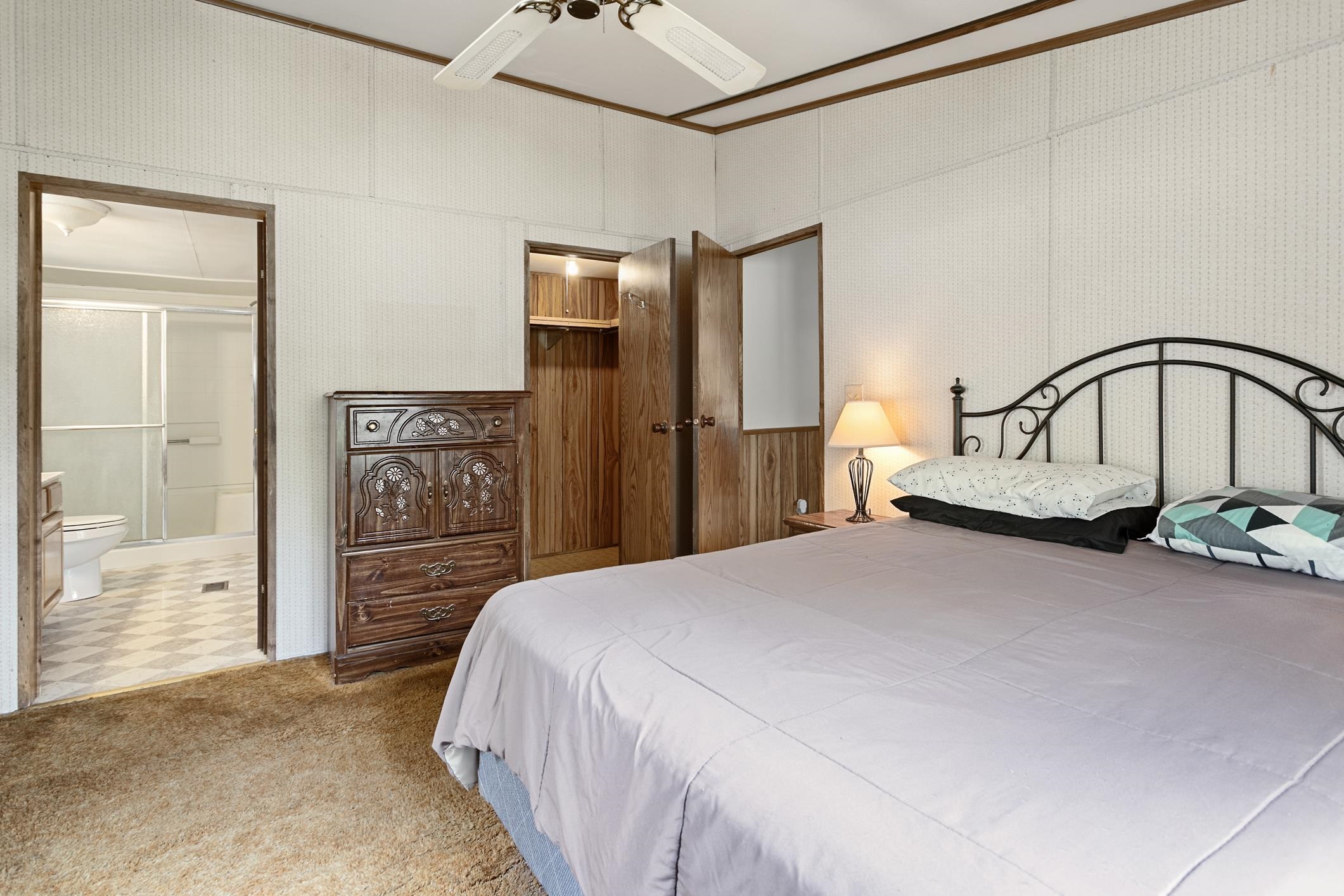3913 Randall Road Green Cove Springs, FL 32043 - Photo 10 of 43 a bedroom with a bed table and a walk in closet