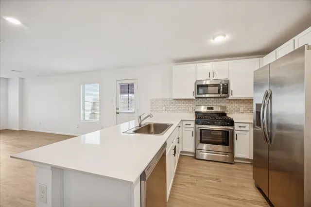 a kitchen with a sink a stove and refrigerator