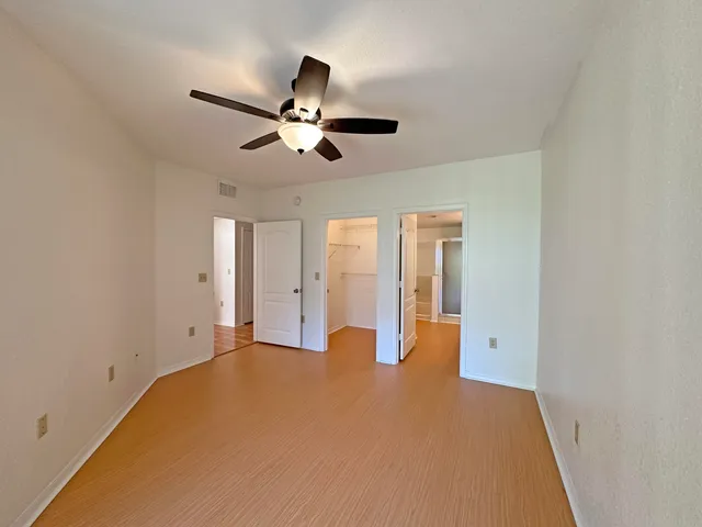 a view of empty room with ceiling fan