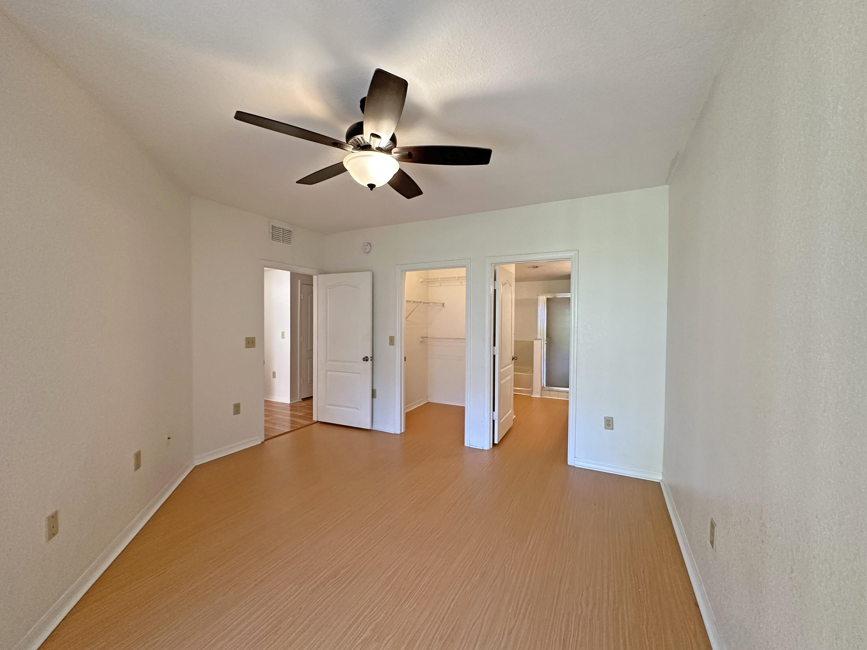 166 Southwest Peacock Boulevard, Unit 104 Port St. Lucie, FL 34986 - Photo 14 of 45 a view of empty room with ceiling fan