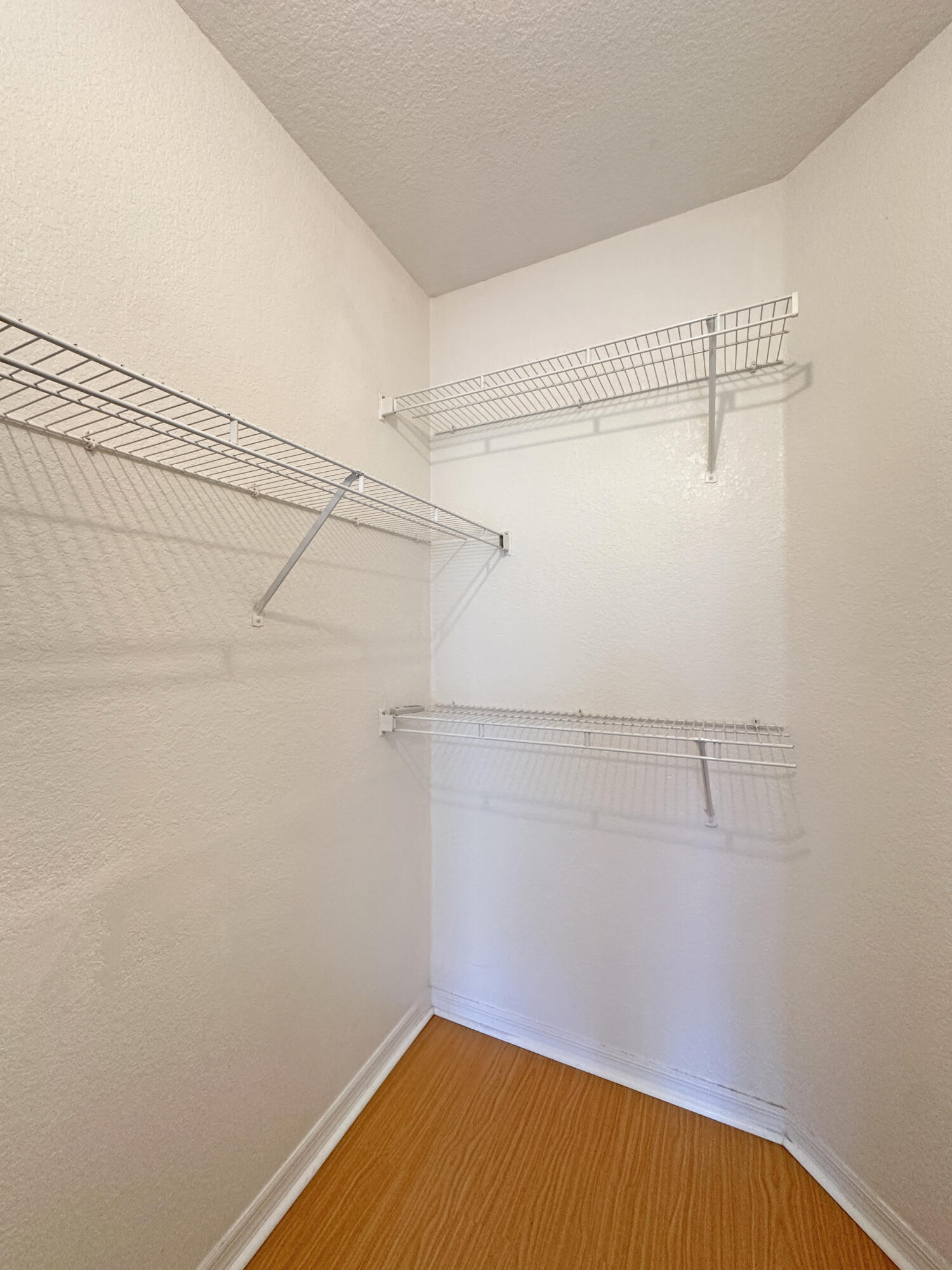 166 Southwest Peacock Boulevard, Unit 104 Port St. Lucie, FL 34986 - Photo 18 of 45 a view of a room with racks on the wall