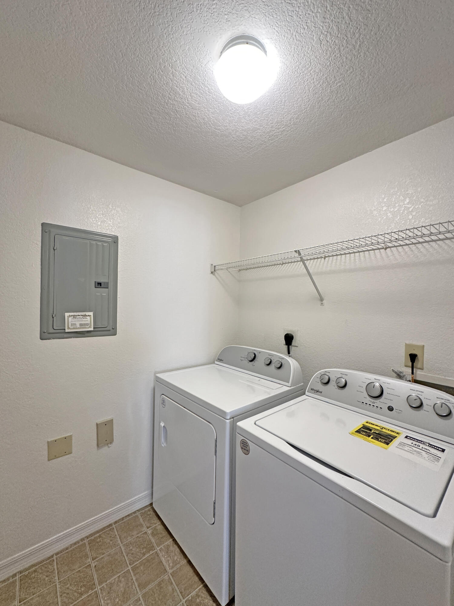 166 Southwest Peacock Boulevard, Unit 104 Port St. Lucie, FL 34986 - Photo 23 of 45 a utility room with dryer and washer