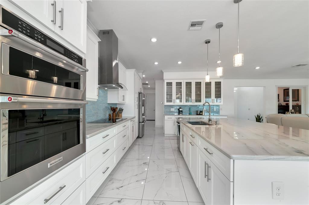 7505 27th Avenue West Bradenton, FL 34209 - Photo 11 of 66 a large white kitchen with a stove top oven