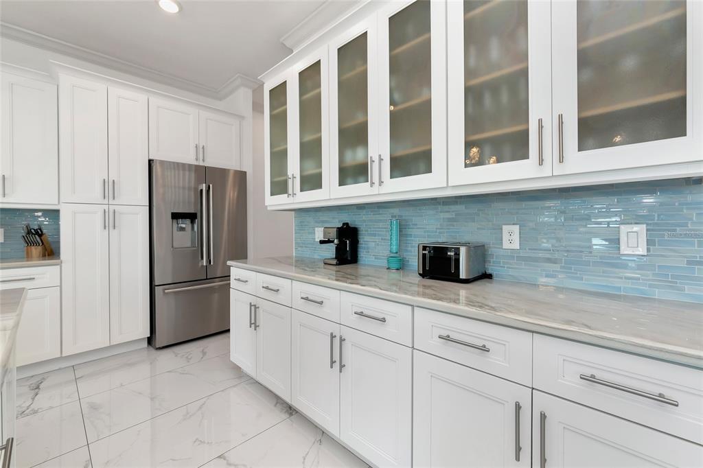 7505 27th Avenue West Bradenton, FL 34209 - Photo 15 of 66 a kitchen with stainless steel appliances granite countertop a refrigerator and cabinets