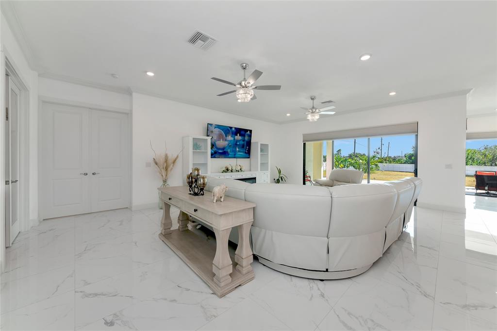 7505 27th Avenue West Bradenton, FL 34209 - Photo 16 of 66 a living room with furniture and a chandelier