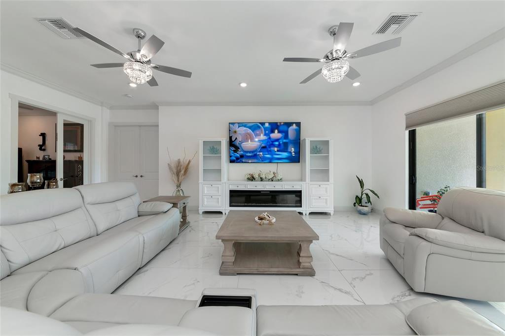 7505 27th Avenue West Bradenton, FL 34209 - Photo 18 of 66 a living room with furniture and a flat screen tv
