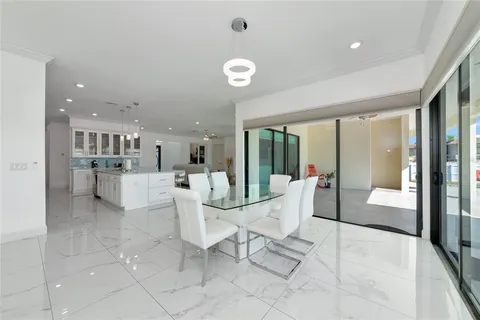 a bedroom with a bed and dresser with mirror