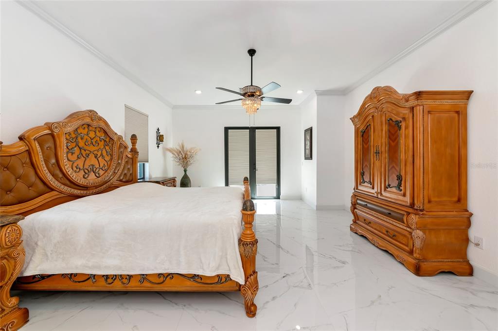 7505 27th Avenue West Bradenton, FL 34209 - Photo 26 of 66 a bedroom with a bed and dresser with mirror