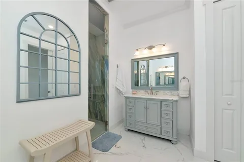 a large bedroom with a bed and a chandelier