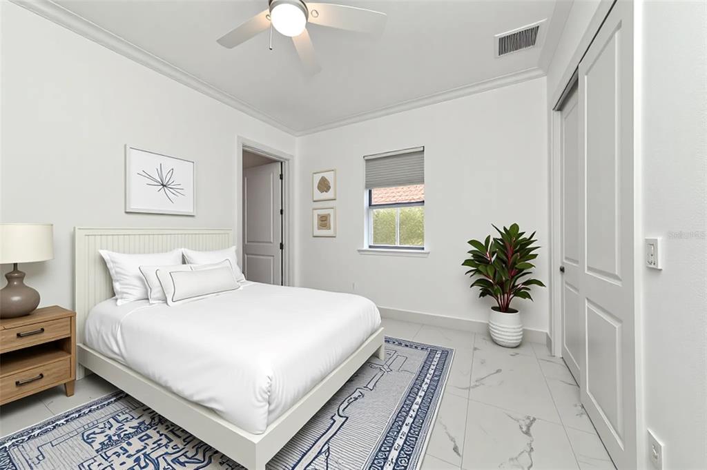 7505 27th Avenue West Bradenton, FL 34209 - Photo 37 of 66 a bedroom with a large bed and a chandelier