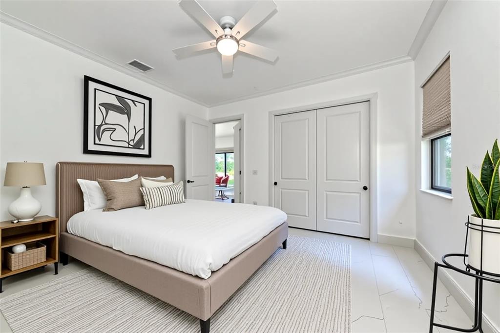 7505 27th Avenue West Bradenton, FL 34209 - Photo 39 of 66 a large bedroom with a bed and a chandelier