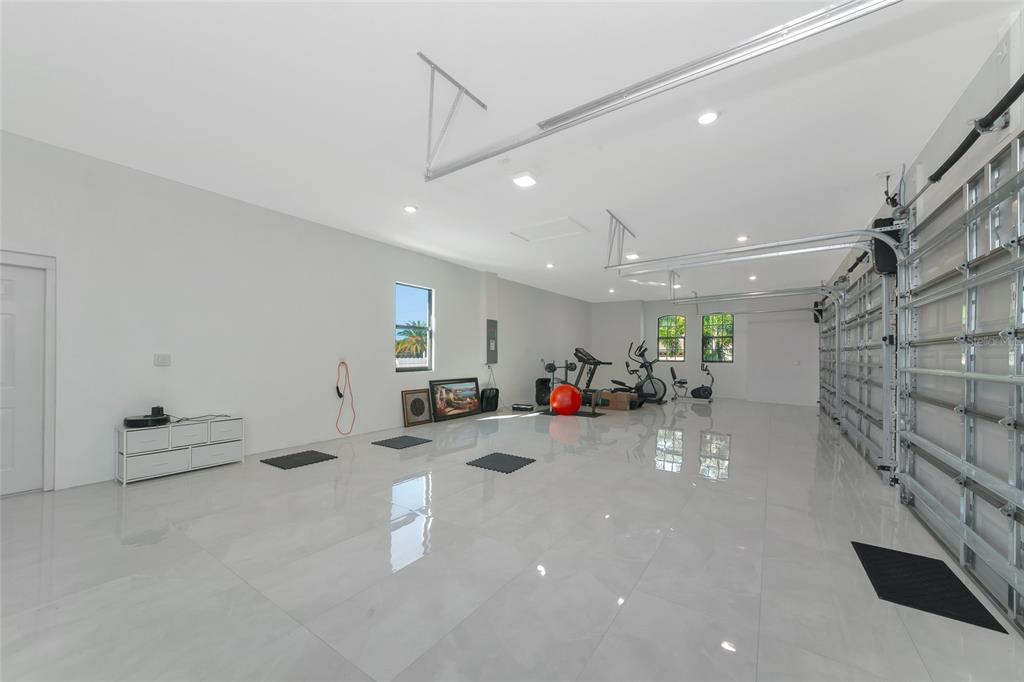 7505 27th Avenue West Bradenton, FL 34209 - Photo 42 of 66 a room with lots of white furniture and a chandelier