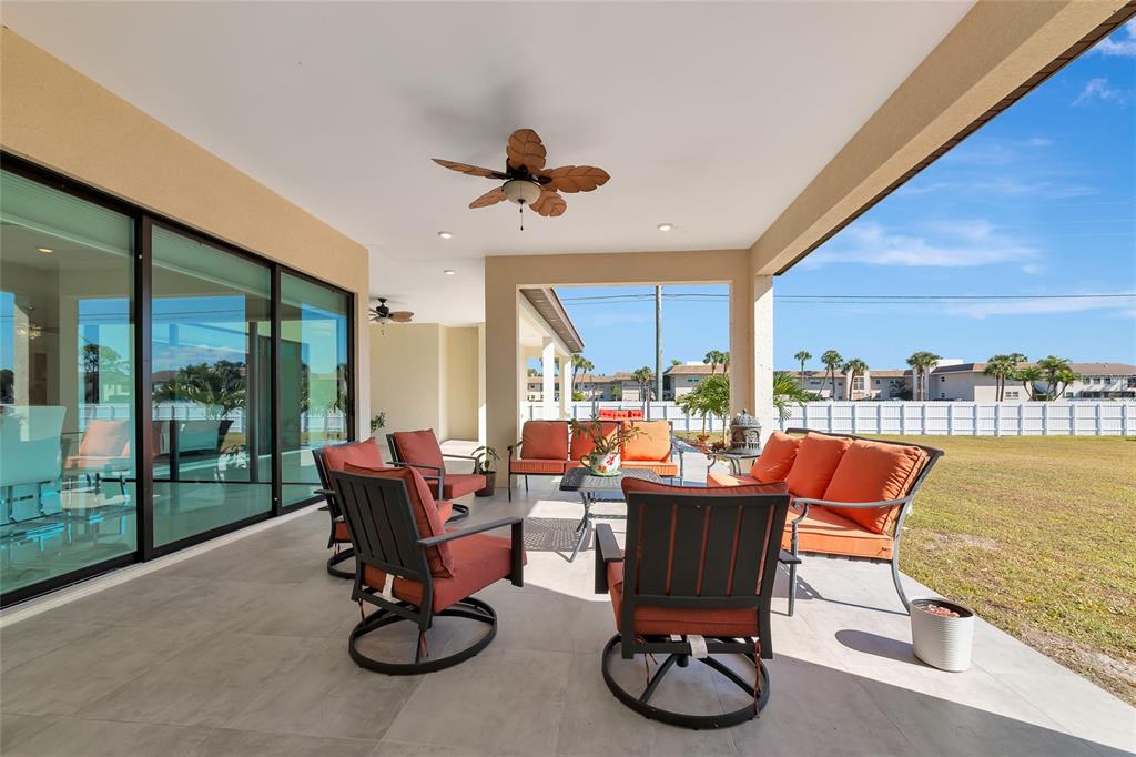 7505 27th Avenue West Bradenton, FL 34209 - Photo 49 of 66 a living room with furniture a floor to ceiling window and a flat screen tv