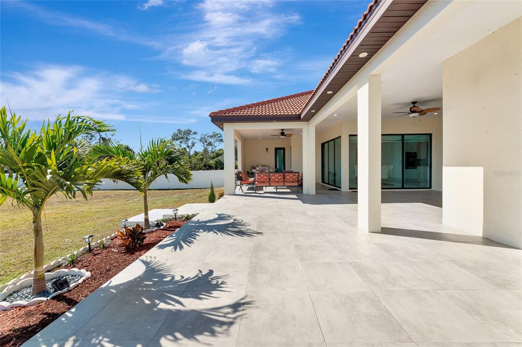 7505 27th Avenue West Bradenton, FL 34209 - Photo 52 of 66 a view of a porch with chairs and floor to ceiling window