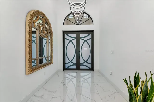 a large kitchen with kitchen island granite countertop lots of counter space and stainless steel appliances