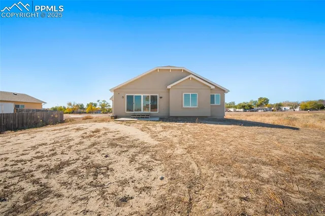 a big house with a big yard and large trees