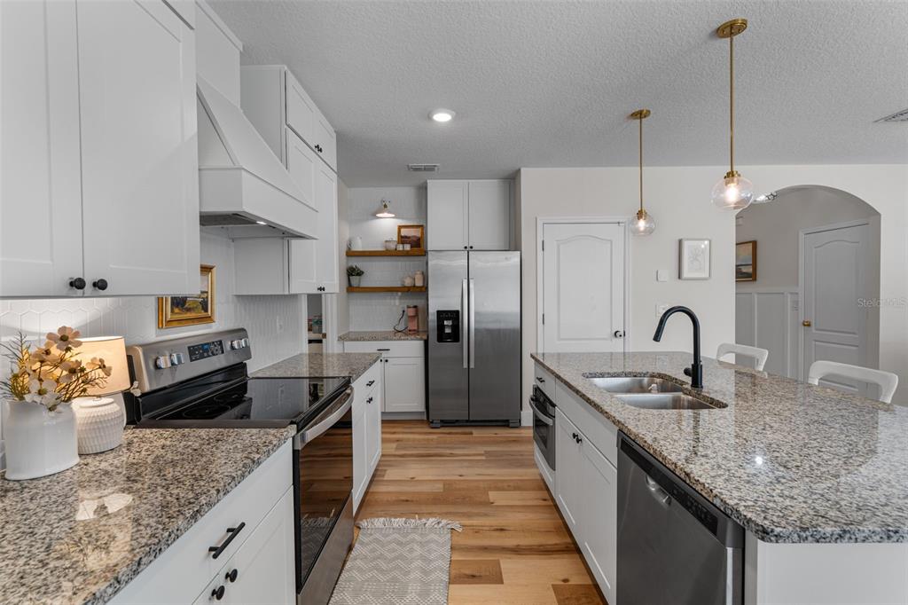 113 Camilla Road DeLand, FL 32724 - Photo 11 of 54 a large kitchen with granite countertop a large counter top stainless steel appliances and cabinets