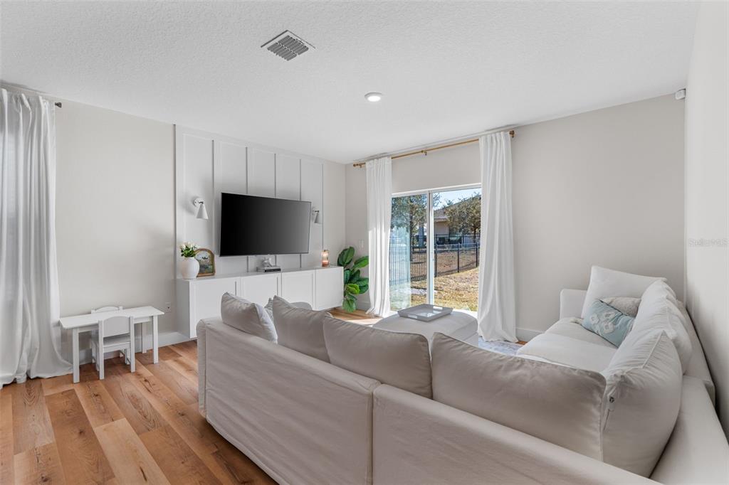 113 Camilla Road DeLand, FL 32724 - Photo 16 of 54 a living room with furniture and a flat screen tv