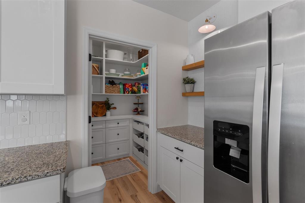 113 Camilla Road DeLand, FL 32724 - Photo 20 of 54 a kitchen with stainless steel appliances granite countertop a refrigerator and a sink