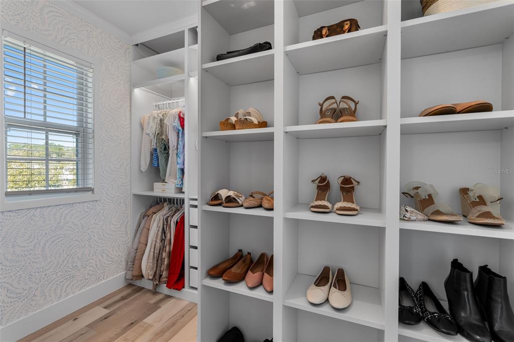 113 Camilla Road DeLand, FL 32724 - Photo 27 of 54 a view of walk in closet with clothes and shoes