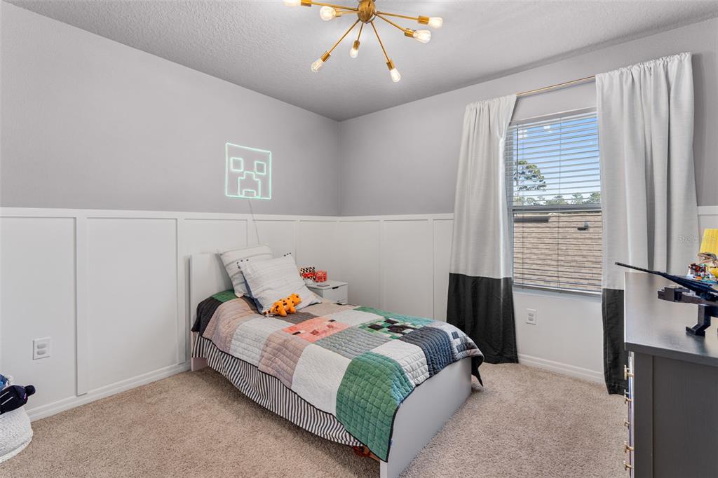 113 Camilla Road DeLand, FL 32724 - Photo 33 of 54 a bedroom with a bed and wooden floor