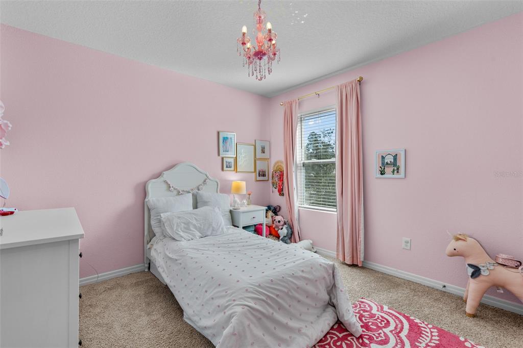 113 Camilla Road DeLand, FL 32724 - Photo 34 of 54 a bedroom with a bed and a chandelier