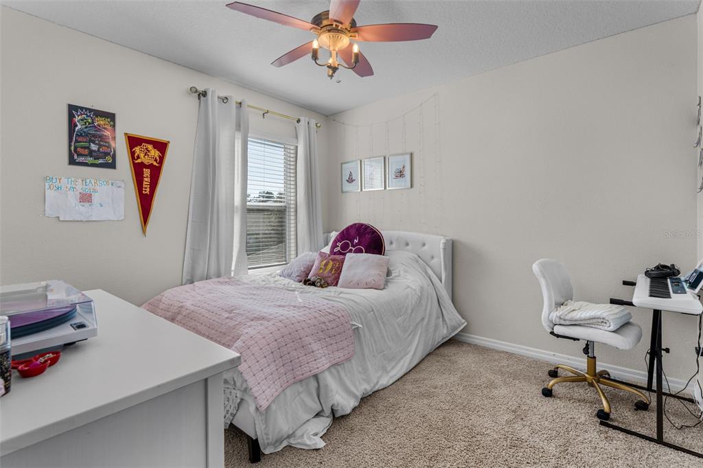 113 Camilla Road DeLand, FL 32724 - Photo 35 of 54 a bedroom with a bed and a chandelier