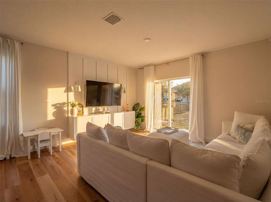113 Camilla Road DeLand, FL 32724 - Photo 40 of 54 a living room with furniture and a flat screen tv