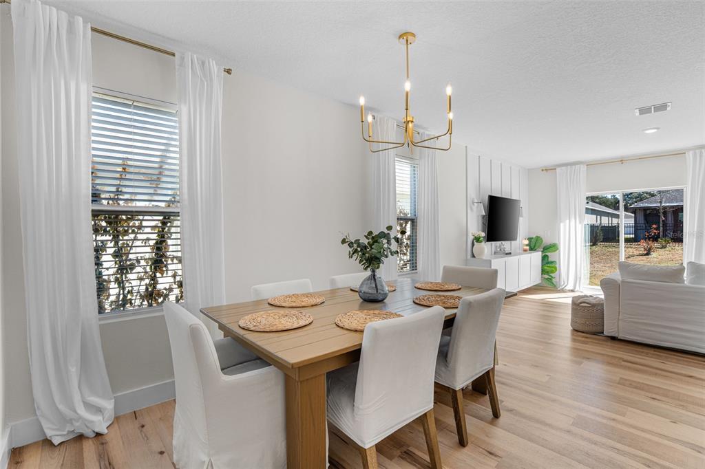 113 Camilla Road DeLand, FL 32724 - Photo 8 of 54 a view of a dining room with furniture window and wooden floor