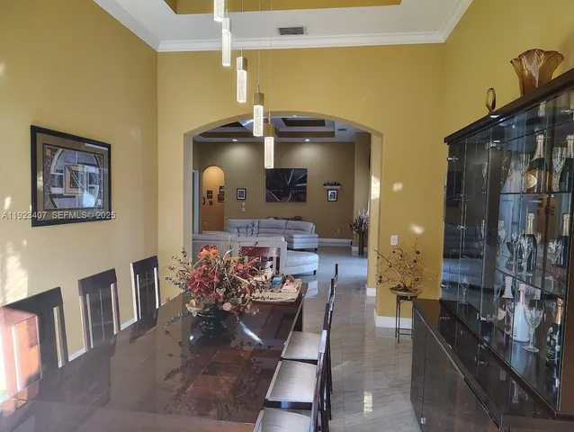 a hallway with furniture and a chandelier