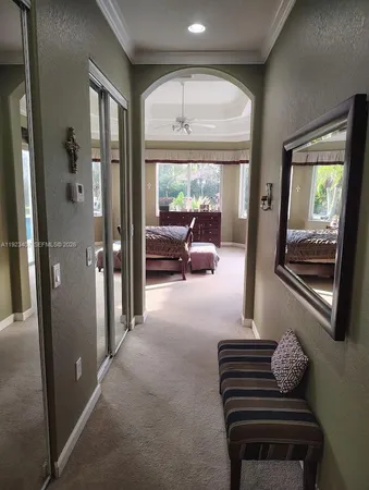 a hallway with furniture and a chandelier