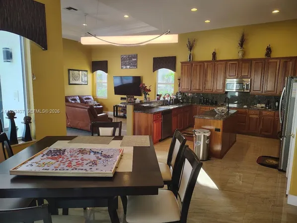 a kitchen with a table chairs stove and refrigerator
