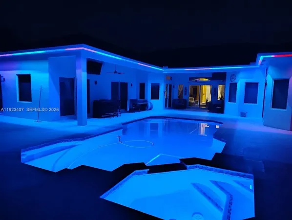 a view of swimming pool with a table and chairs