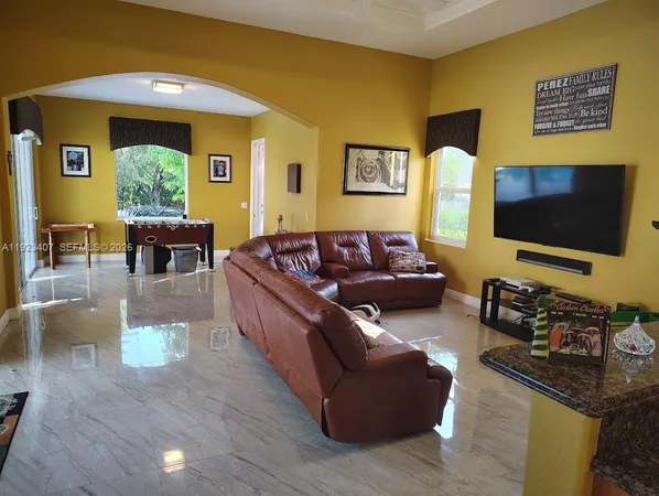 a living room with fireplace furniture and a flat screen tv