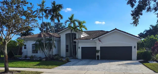 a view of a house with garden and trees