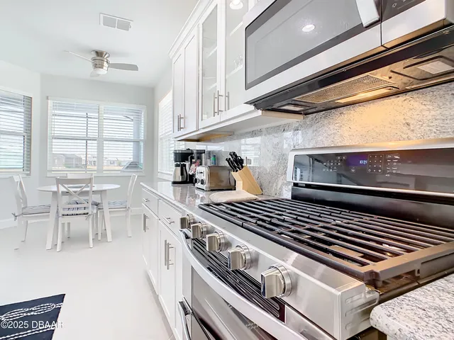 a kitchen with a sink stove and refrigerator
