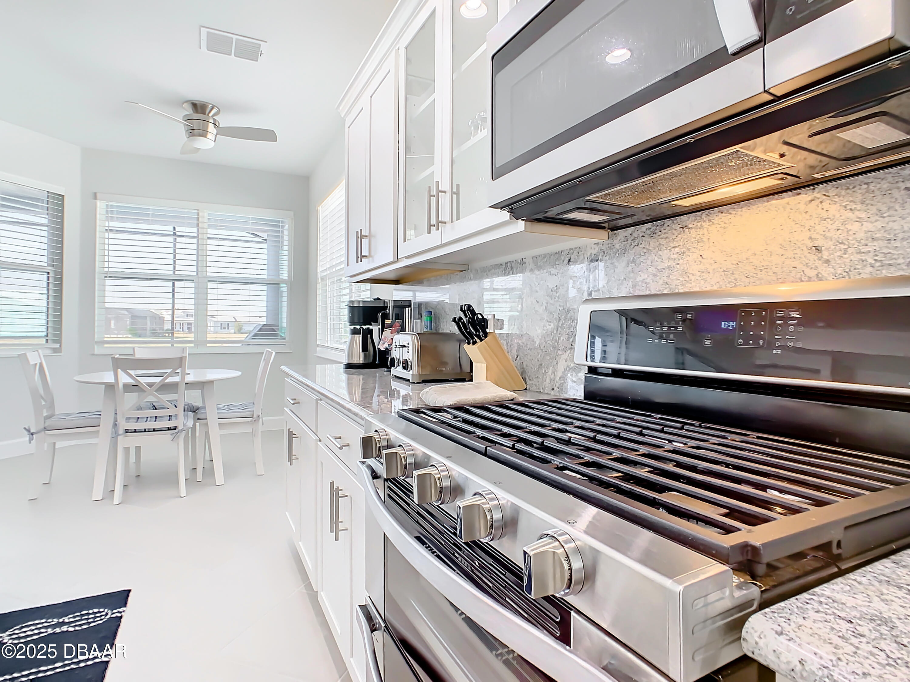 205 Cheeseburger Drive Daytona Beach, FL 32124 - Photo 21 of 79 a kitchen with a stove and a microwave