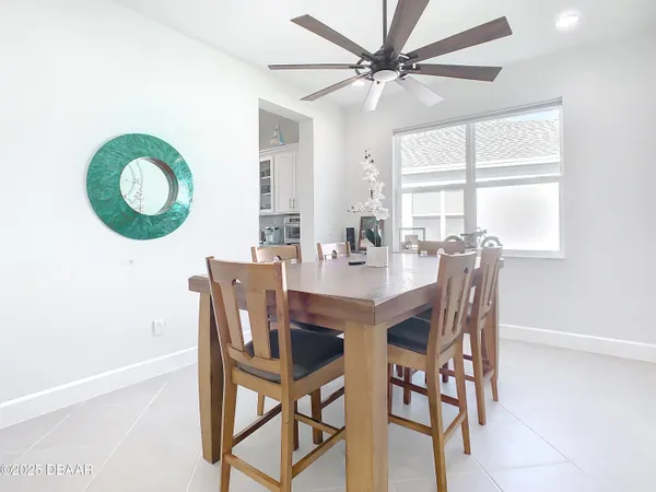 a view of a dining room with furniture and a chandelier