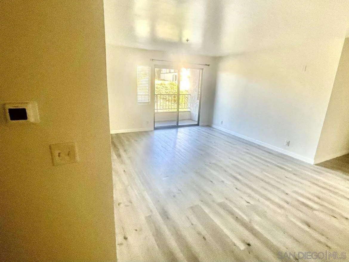 3980 Faircross Place, Unit 23 San Diego, CA 92115 - Photo 11 of 21 a view of an empty room with wooden floor and a window