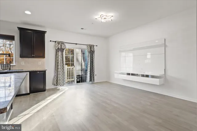 a view of a kitchen with a sink and a large window