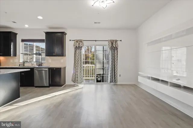 a view of a kitchen with stainless steel appliances granite countertop a stove and a sink