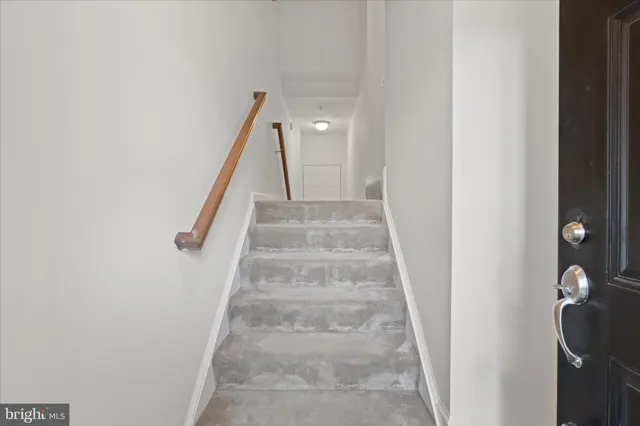 a view of staircase with white walls