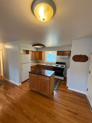 a kitchen with stainless steel appliances granite countertop a stove and a refrigerator