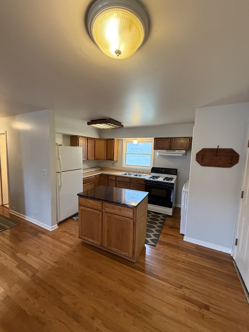 222 West Park Road Round Lake, IL 60073 - Photo 3 of 7 a kitchen with stainless steel appliances granite countertop a stove and a refrigerator